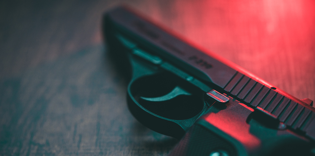 Red lighting hand gun hand gun on red